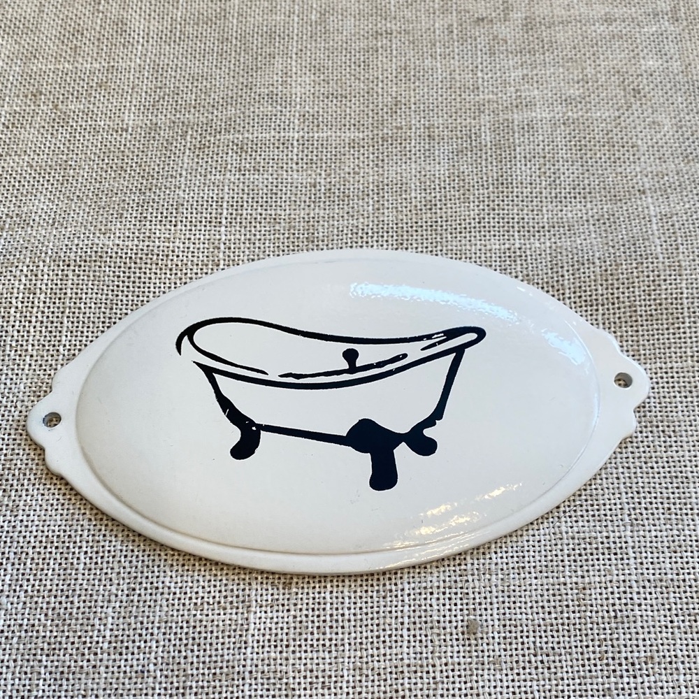 Enameled metal bath tub sign.